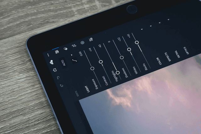 Photo editing app on tablet displaying sky image.
