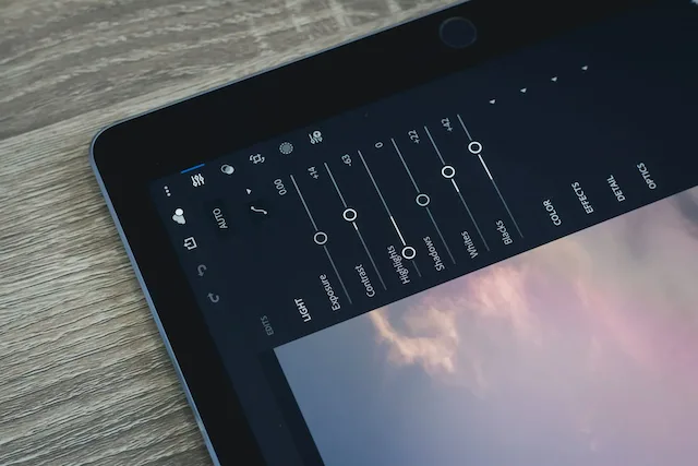 Photo editing app on tablet displaying sky image.
